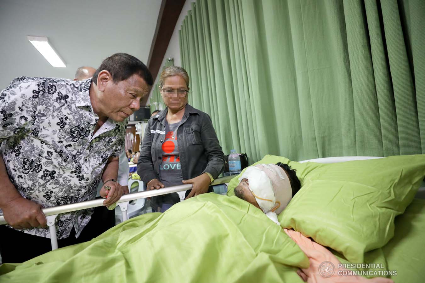 President Rodrigo Roa Duterte checks the condition of one of the wounded law enforcers he visited at the Divine Word Hospital in Tacloban City on November 15, 2019. ACE MORANDANTE/PRESIDENTIAL PHOTO